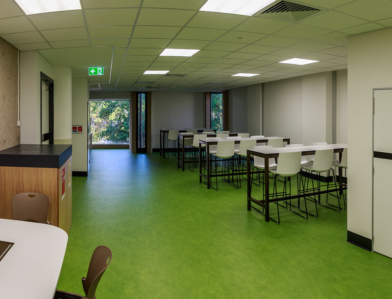 Central Library kitchenette with three high group tables with seating