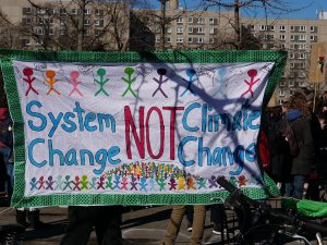 System change not climate change banner at protest