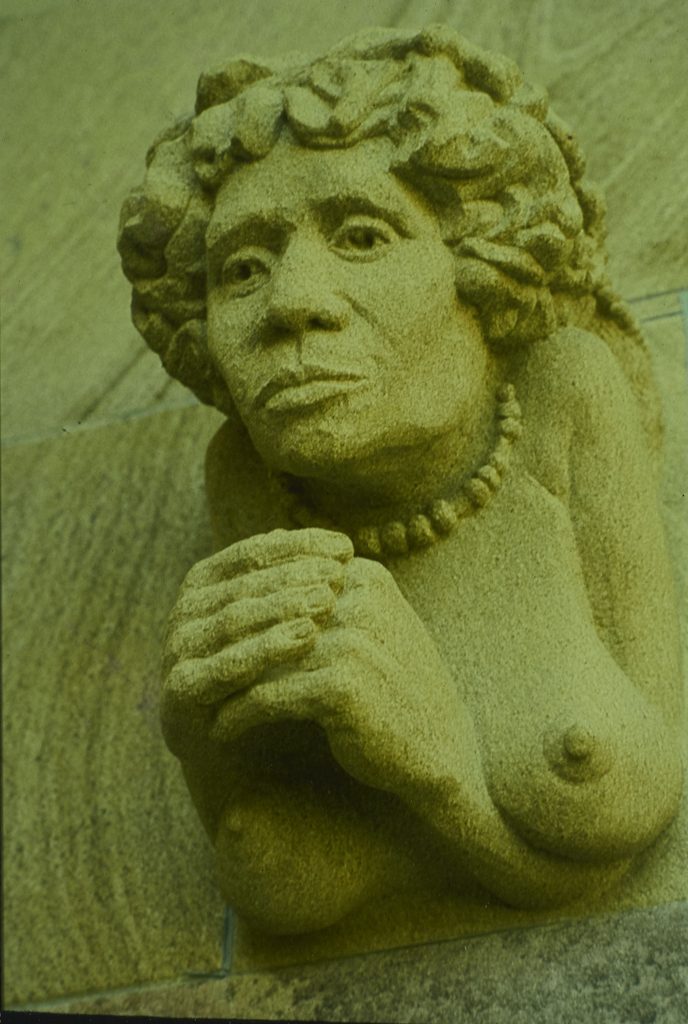 Sandstone haut-relief grotesque depiction of an Aboriginal woman